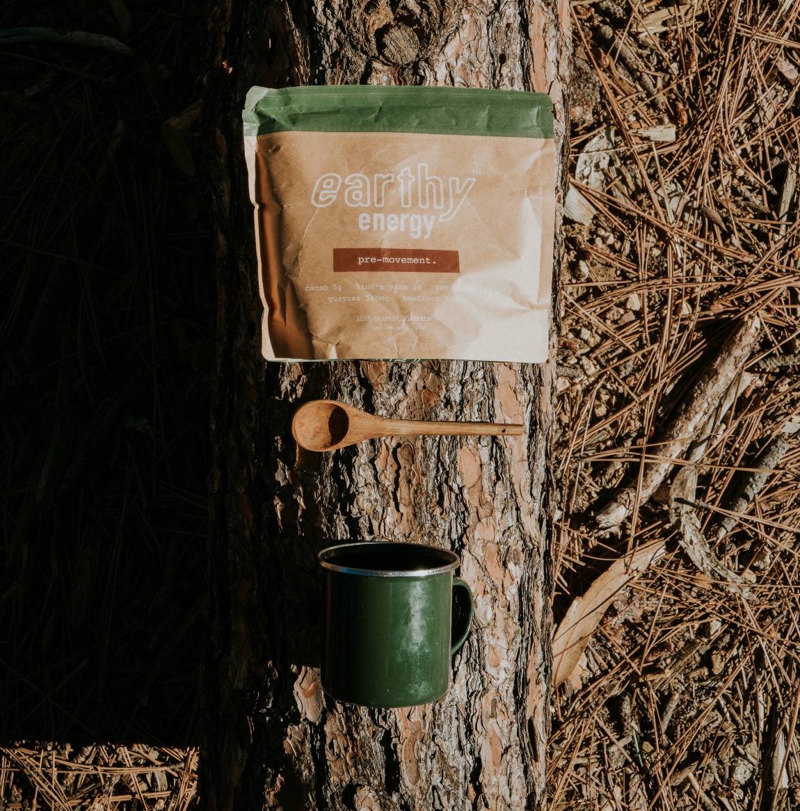 'Brown and green 'Earthy Energy' product bag against a beige background.'